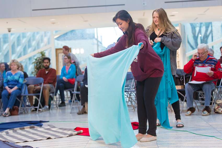 Student volunteers prepare for a Kairos Blanket Exercise at Edmonton City Hall in 2016. The Exercise was created as an interactive way of learning Indigenous history.